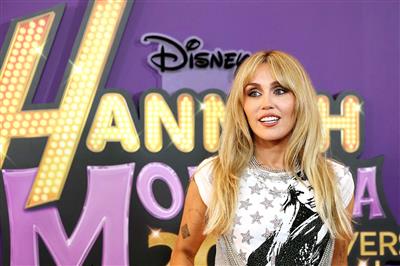 Miley Cyrus all smiles as she attends premiere of Hannah Montana 20th Anniversary Special